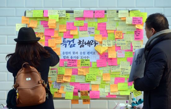20일 오후 서울 강남구 박영수 특별검사 사무실 앞에서 한 시민이 특검을 응원하는 메모를 벽에 붙이고 있다. 뉴시스