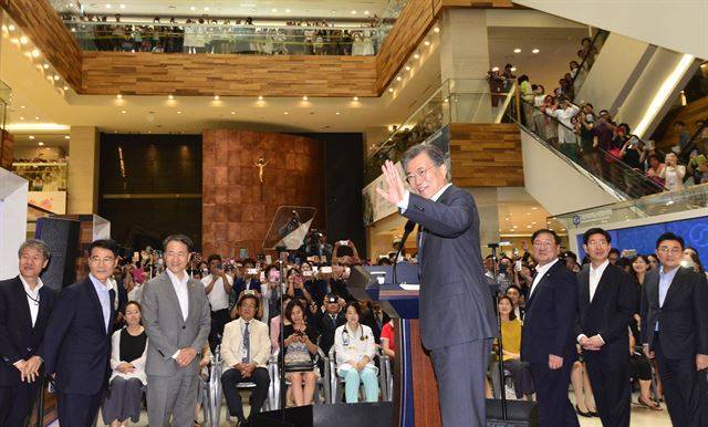 문재인 대통령이 9일 오후 서울 서초구 서울성모병원을 방문, 건강보험 보장 강화정책을 발표하기 앞서 환호하는 환자, 보호자, 의료진에게 손을 들어 인사하고 있다. 연합뉴스