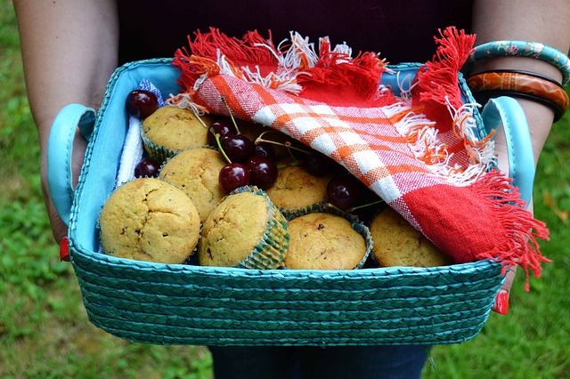 The basket with the red ribon is filled with desserts for your guests.
