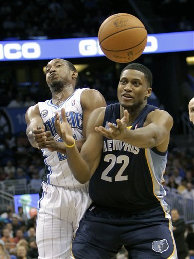 Orlando Magic Point Guard Chris Duhon, Left, And Memphis Grizzlies Forward Rudy Gay (22) Collide While Going For A