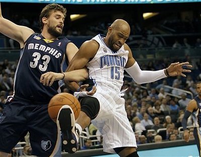 Memphis Grizzlies Center Marc Gasol (33), Of Spain, And Orlando Magic Guard Vince Carter (15) Lock Arms While Going For
