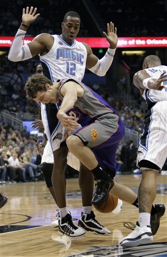 Phoenix Suns Point Guard Goran Dragic, Center, Of Slovenia, Loses Control Of The Ball As He Tries To Get Between