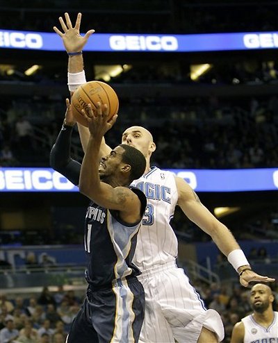 Memphis Grizzlies Point Guard Mike Conley, Left, Gets Off A Shot In Front Of Orlando Magic Center Marcin Gortat, Of