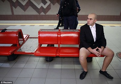 Waiting patiently: A businessmen sits in his black suit and shirt, minus the trousers