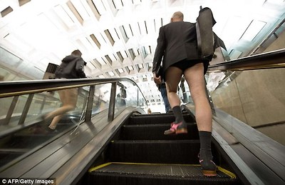 Going up: A man wearing smart shoes with a pink trim reveals his black underwear as he walks up an escalator at a Metro station in Washington D.C.