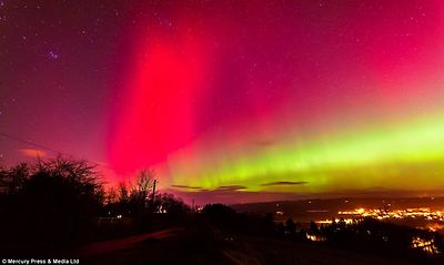 Bright: People across the UK revelled in a rare glimpse of the Northern Lights - stretching as far down as East Anglia. Above, the sky turns pink and yellow