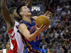 Knicks point guard Jeremy Lin, here driving the lane in Tuesday's win vs. the Raptors, hit a three-point shot with .5 seconds left to rally New York to its sixth consecutive victory. Knicks point guard Jeremy Lin, here driving the lane in Tuesday's win vs. the Raptors, hit a three-point shot with .5 seconds left to rally New York to its sixth consecutive victory.