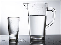 A pitcher and glass of water
