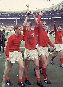 Sir Bobby Charlton (centre) is flanked by Alan Ball (left) and Sir Bobby Moore (right) after England's win over Germany in the 1966 World Cup final