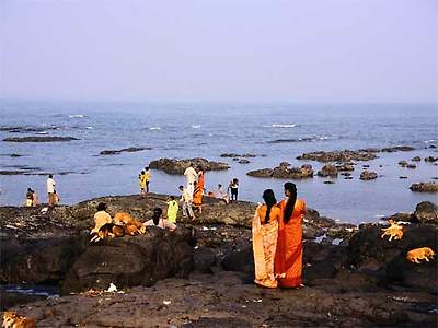  People and dogs on rocks near Mahalaxmi Temple