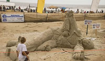 Angels and demons with a man at the Nepture Festival, Virginia Beach Sandsculpting Championship