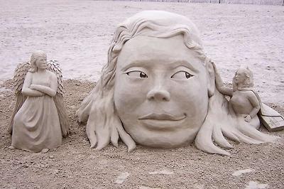 Sand Creations - This was temptation. A devil on one side with Godiva chocolates under her cape and an angered angel on the other. Hampton Beach, NH