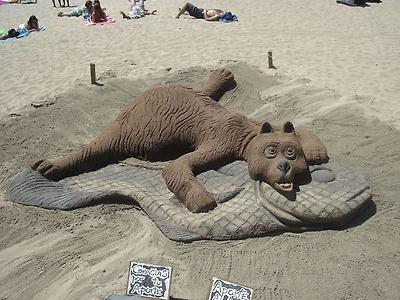bear on a fish rug animal sand sculpture  sandpainting