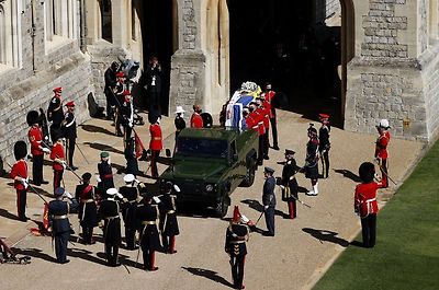 The Duke of Edinburgh's coffin, covered with His Royal Highness's Personal Standard is carried to the purpose built Land Rover during the funeral of Prince Philip, Duke of Edinburgh at Windsor Castle data-on April 17, 2021