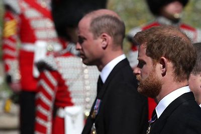 Prince William, Duke of Cambridge, (L) and Britain's Prince Harry, Duke of Sussex follow the coffin during the ceremonial funeral procession of Prince Philip, Duke of Edinburgh to St George's Chapel in Windsor Castle in Windsor, data-on April 17, 2021.