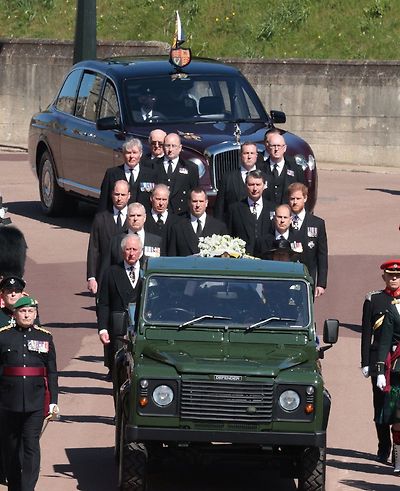 Queen Elizabeth in the Bentley State Limousine and members of the Royal Family follow the hearse during the funeral of Britain's Prince Philip, who died at the age of 99, data-on the grounds of Windsor Castle in Windsor, Britain, April 17, 2021.