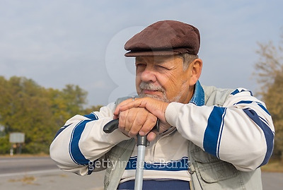 outdoor portrait of senior man with walking stick