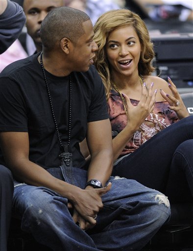 Entertainers Jay-Z, Left, And Beyonce Attend The New Jersey Nets Against The Detroit Pistons NBA Basketball Game