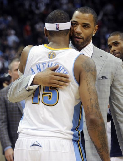 Denver Nuggets Forward Kenyon Martin, Right, Gives