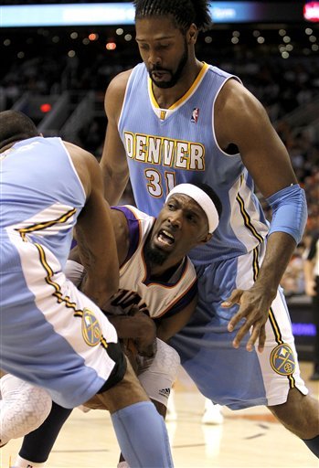 Phoenix Suns' Hakim Warrick, Middle, Gets Tied Up For A Jump Ball By Denver Nuggets' Arron Afflalo As Nuggets' Nene (31)