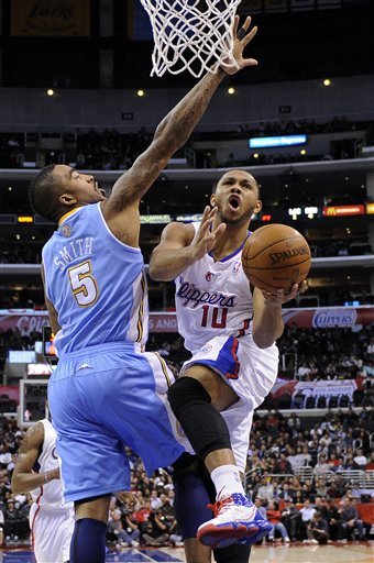 Los Angeles Clippers Guard Eric Gordon, Right, Goes