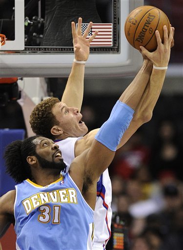 Denver Nuggets Center Nene Hilario, Left, Of Brazil And Los Angeles Clippers Forward Blake Griffin Go