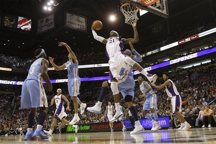 Phoenix Suns' Hakim Warrick (21) Grabs A Rebound From Denver Nuggets' Carmelo Anthony, Back, As Nuggets' Ty Lawson (3),