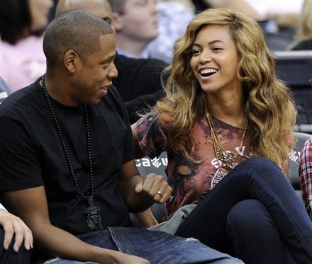 Entertainers Jay-Z, Left, And Beyonce Watch The New Jersey Nets And The Detroit Pistons Play