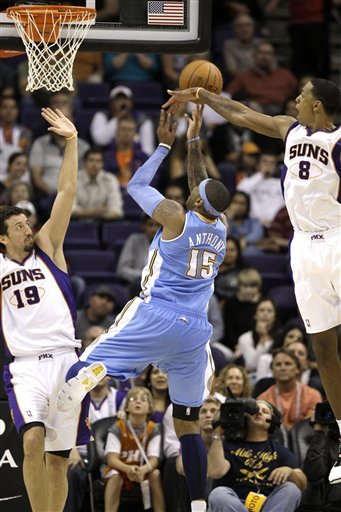 Denver Nuggets' Carmelo Anthony (15) Gets Off A Shot As He Is Defended Closely By Phoenix Suns' Channing Frye (8) And