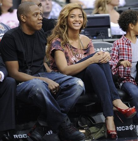 Entertainers Jay-Z, Left, And Beyonce Watch The New Jersey Nets And The Detroit Pistons Play