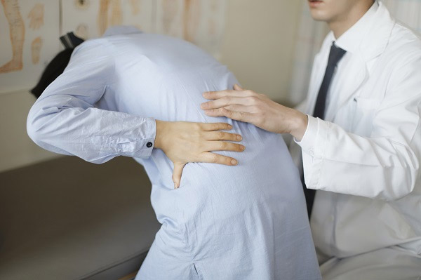 허리 아파하는 사람과 의사