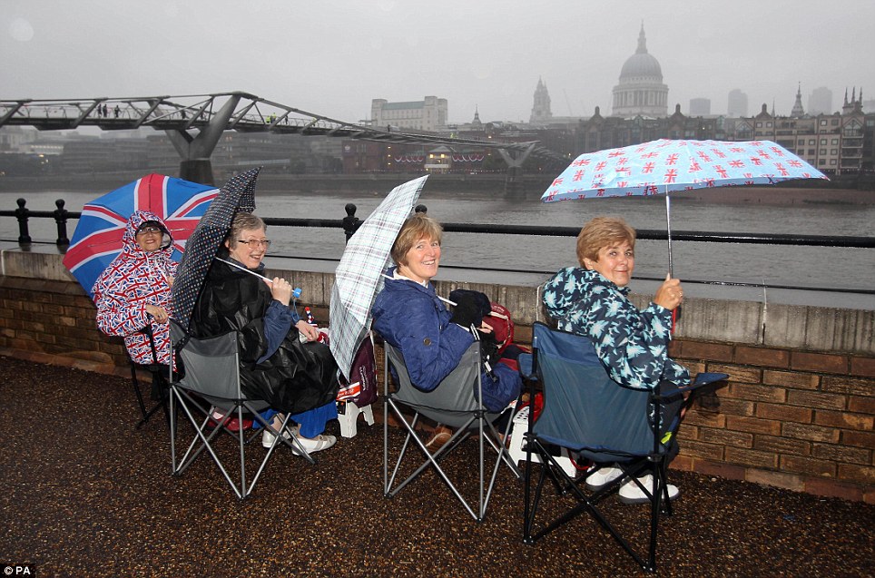 Royal revellers wait in the rain on the South Bank of the River Thames for the start of the Diamond Jubilee