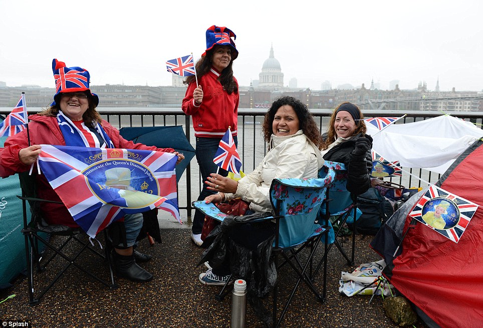 A group of women who camped overnight celebrate as they wait for the Diamond Jubilee celebrations to start