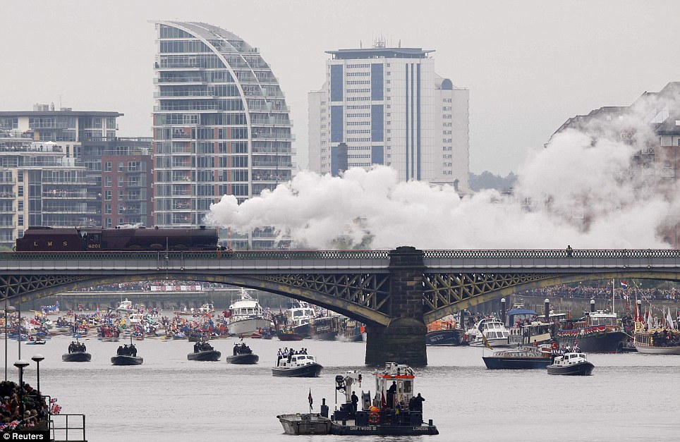A steam train and pleasure boat of all shapes and sizes are seen from Battersea bridge on the River Thames as the Queen celebrates her Diamond Jubilee