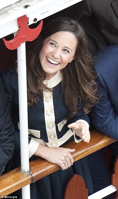 A delighted-looking Pippa Middleton smiles as she makes her way down the Thames