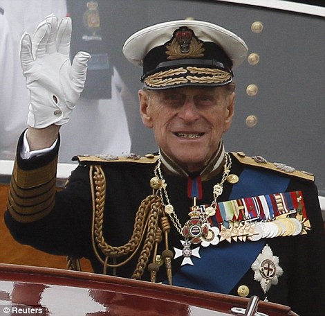 Prince Philip waves from a boat during a pageant in celebration of the Queen's Diamond Jubilee along the River Thames