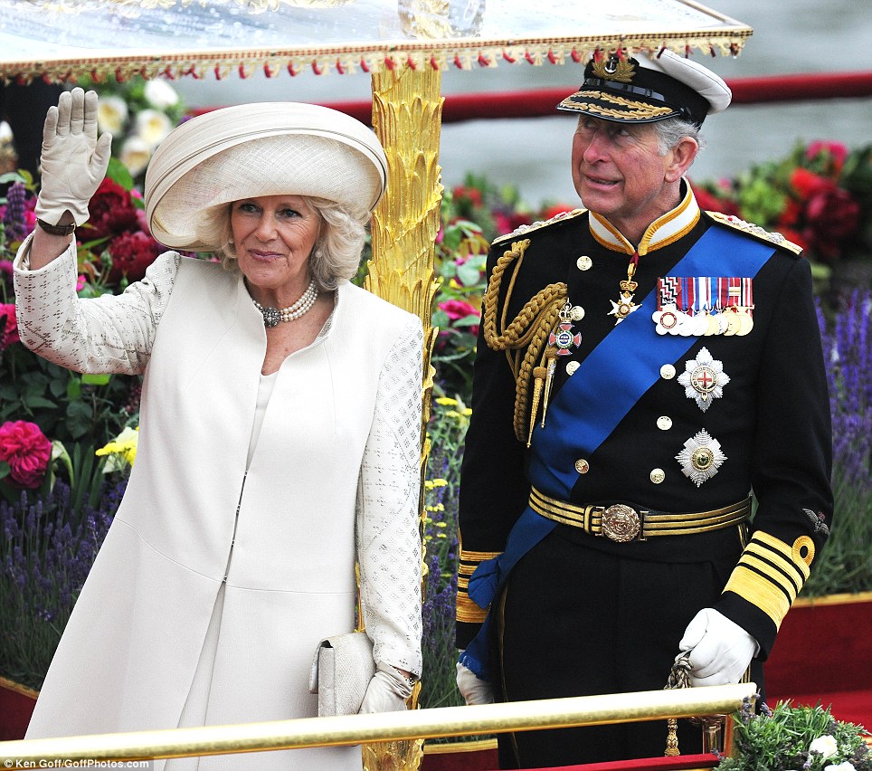 Weather watch: Prince Charles, Prince of Wales, casts a wary eye skywards as rainclouds darken overhead while he accompanies Camilla, Duchess of Cornwall during the Diamond Jubilee River Pageant