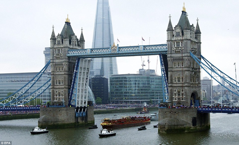 The Spirit of Chartwell Royal barge passes under Tower Bridge, heading up a flotilla of hundreds of boats which sailed from Battersea Bridge to Tower Bridge to celebrate the Queen's Diamond Jubillee