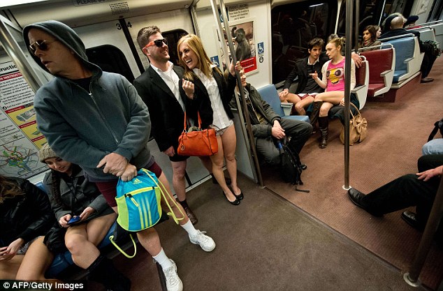 Smartly-dressed: A couple opted for business attire during their journey in the American capital, while others kept warm by wearing a hoodie