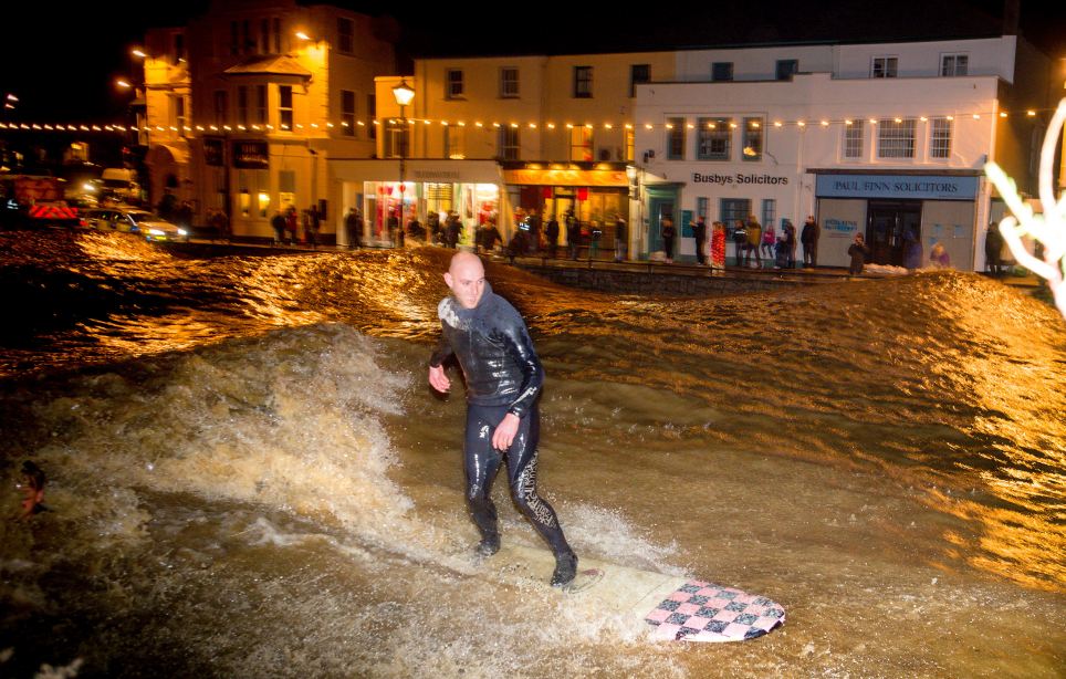 Surfers took a more lighthearted approach to the weather and decided to swap their cars for boards to get around Bude in north Cornwall