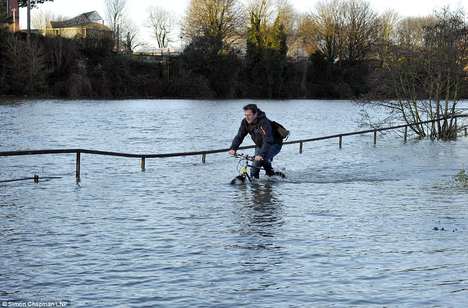 Brave: A cyclist on a flooded cycle path by the River Avon and Cumberland Road didn't let flooding put him off getting on his bike