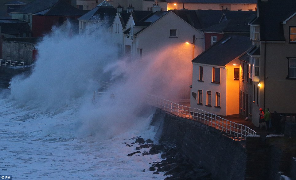 Large waves caused by high winds and spring tides batter the coastal town of Lahinch in Co Clare, Ireland