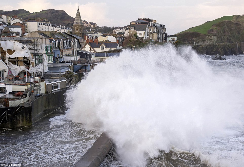 Waves crash into Ilfracombe Harbour at high tide in Devon today as more bad weather heads towards the UK