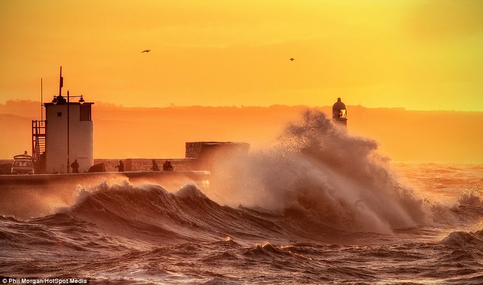 A photographer captures the waves crashing against Porthcawl in Wales this morning