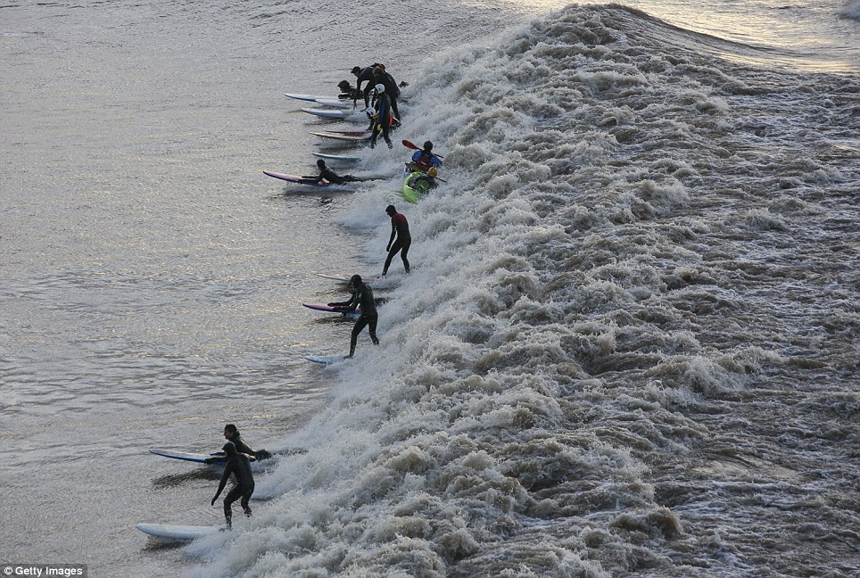 Surf's up: People attempt to ride the Severn Bore - one of Britain's few truly spectacular natural phenomena