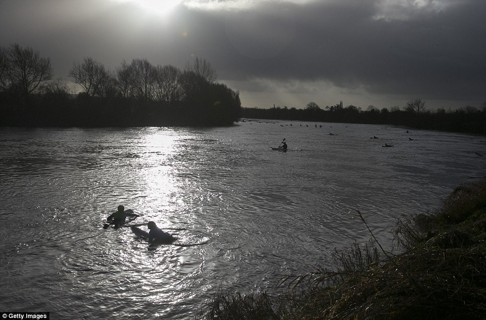 Unusual: Surfers wait to attempt to ride a rare maximum five star Severn Bore at the Severn Bore Inn besides the River Severn in Gloucestershire