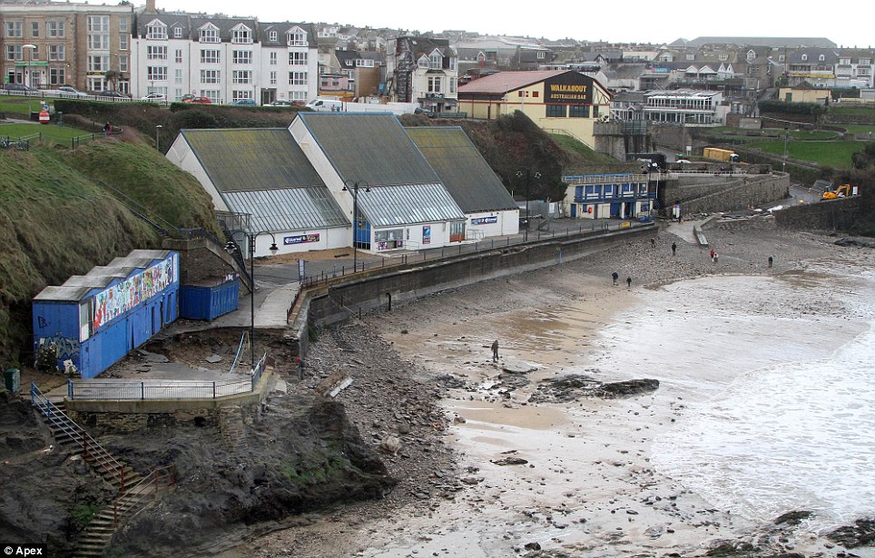 Destructive: Overnight storms carve out a huge hole on a section of seafront at Towan Beach in Newquay, Cornwall