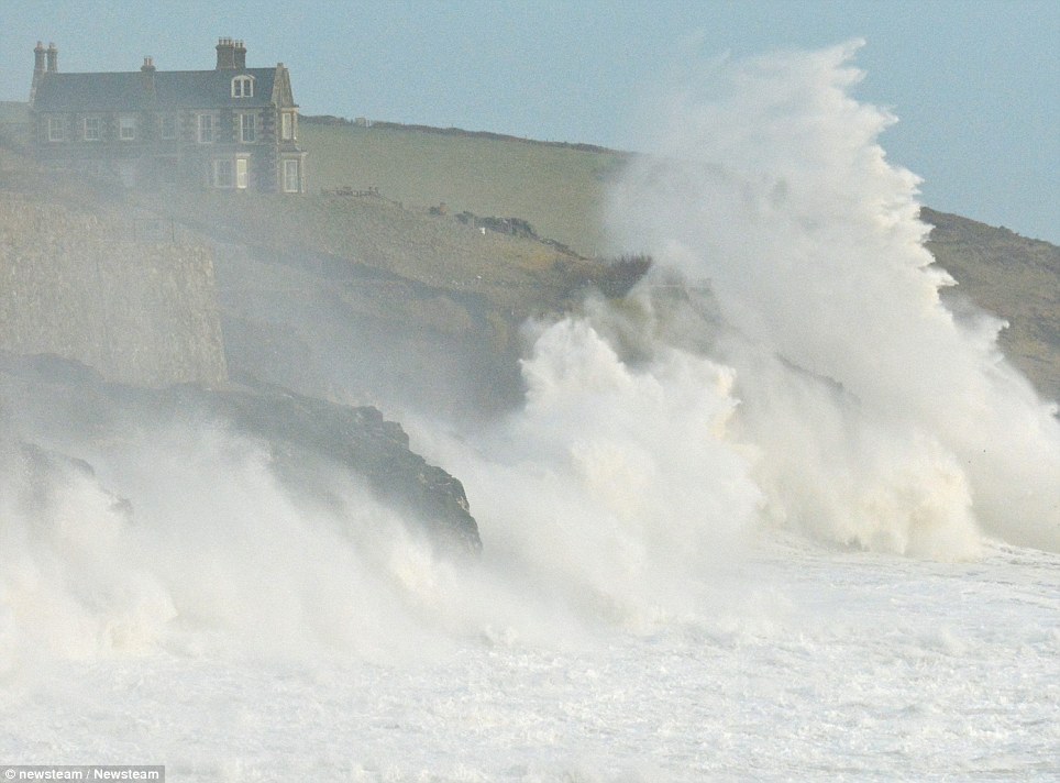 Crash: Stormy seas at Porthleven in Cornwall, as the waves pound into the cliffs under Tye Rock Manor