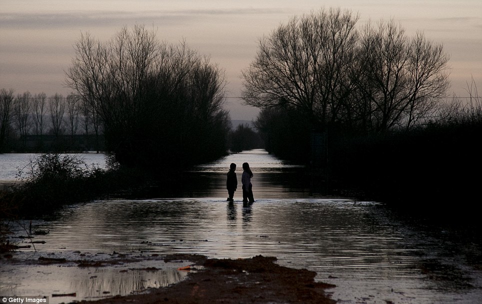 Having fun: Children play in flood water blocking the main A361 at Burrow Bridge on February 2, 2014 near Langport in Somerset