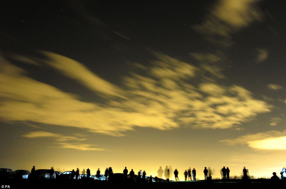 Spectators: Dozens of people gathered to watch the breathtaking display of lights at Whitely Bay in North Tyneside last night